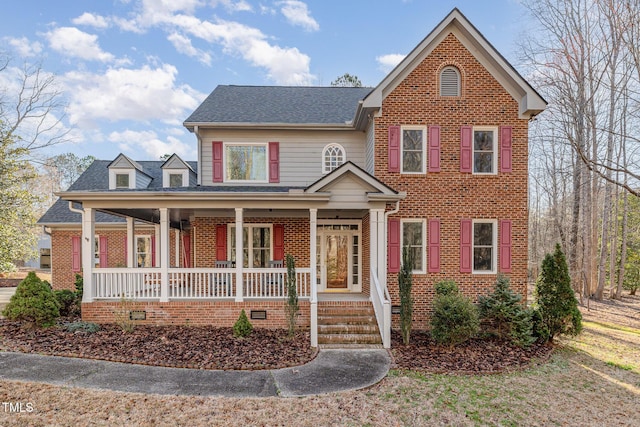 traditional home featuring crawl space, brick siding, a porch, and roof with shingles