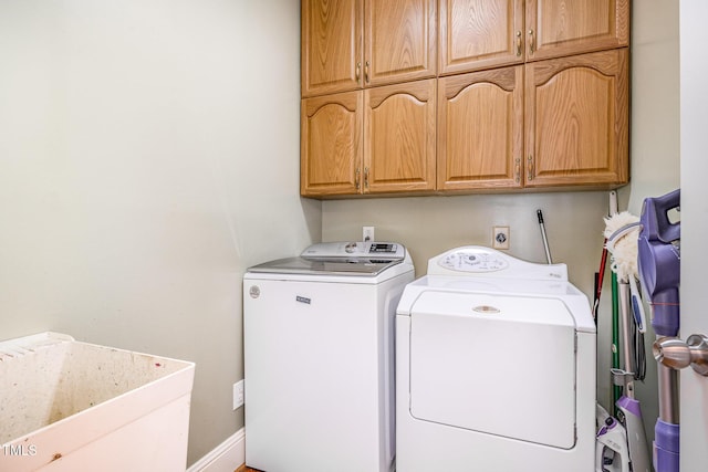 laundry area with washer and dryer, cabinet space, and a sink