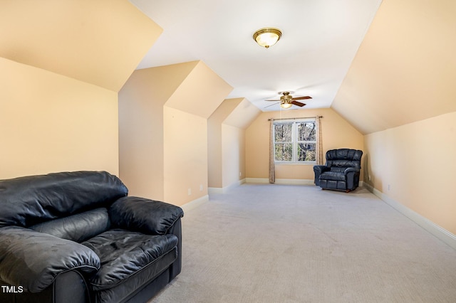 sitting room featuring baseboards, light colored carpet, and vaulted ceiling