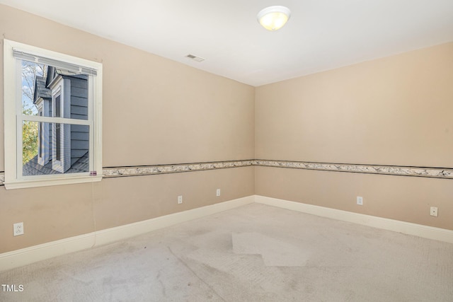 spare room featuring visible vents, baseboards, and carpet