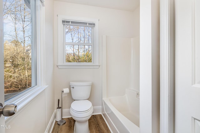 full bathroom with toilet, wood finished floors, and baseboards