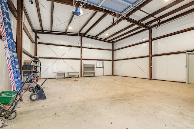 garage featuring metal wall and a garage door opener