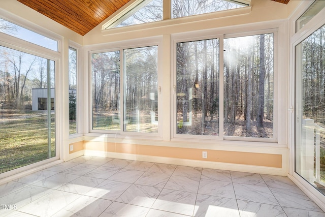 unfurnished sunroom with a healthy amount of sunlight, wood ceiling, and lofted ceiling