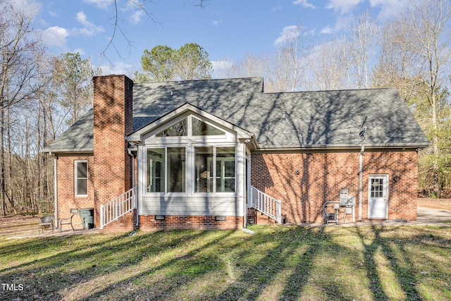 view of front of property featuring entry steps, a front lawn, a chimney, and crawl space