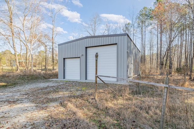 view of outdoor structure featuring an outbuilding and fence