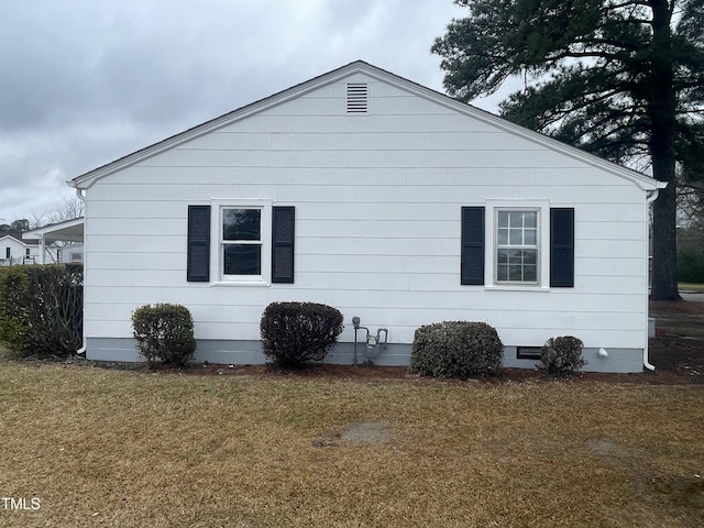 view of home's exterior with crawl space and a lawn