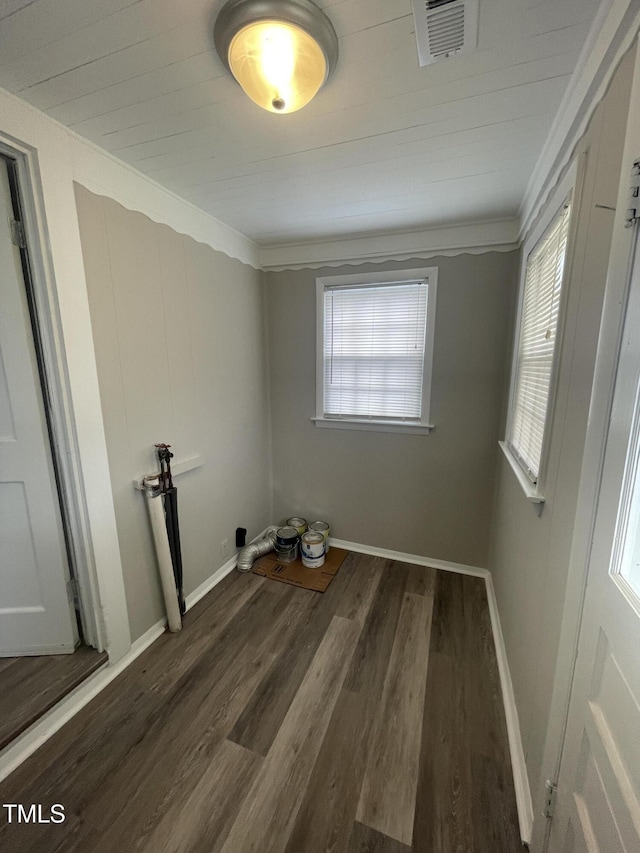 spare room with visible vents, baseboards, and wood finished floors