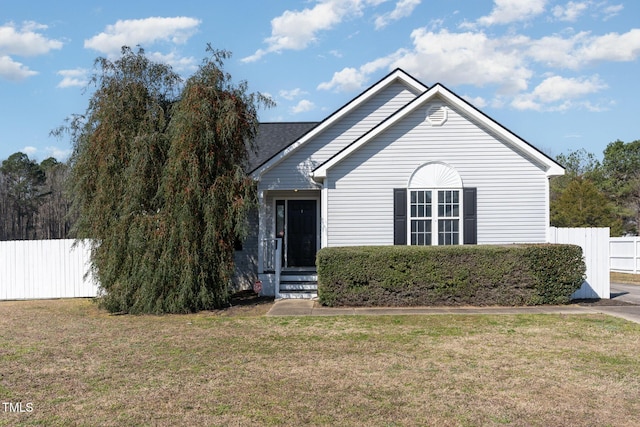 view of front of home featuring a front yard and fence