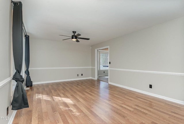 unfurnished living room featuring a ceiling fan, baseboards, and light wood-type flooring