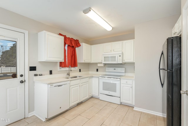 kitchen with white cabinets, white appliances, light countertops, and a sink