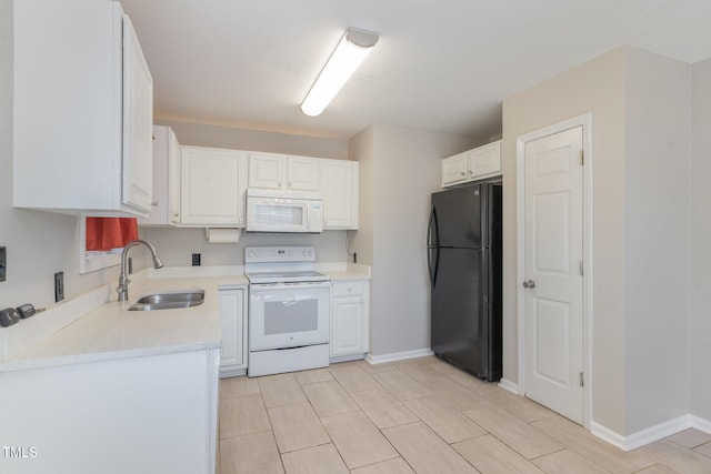 kitchen with a sink, white appliances, white cabinets, light countertops, and baseboards