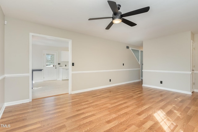 empty room featuring baseboards, light wood-style floors, and ceiling fan