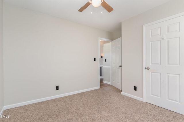 unfurnished bedroom featuring carpet flooring, a ceiling fan, and baseboards