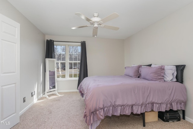 carpeted bedroom with a ceiling fan and baseboards