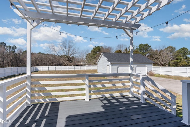 wooden deck featuring an outbuilding, fence, and a pergola