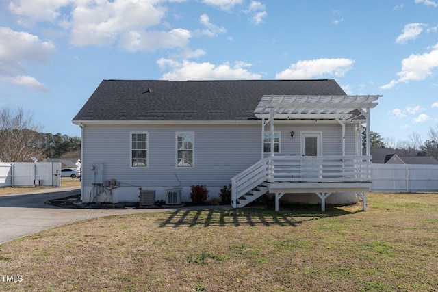 back of property featuring a yard, cooling unit, a pergola, and fence