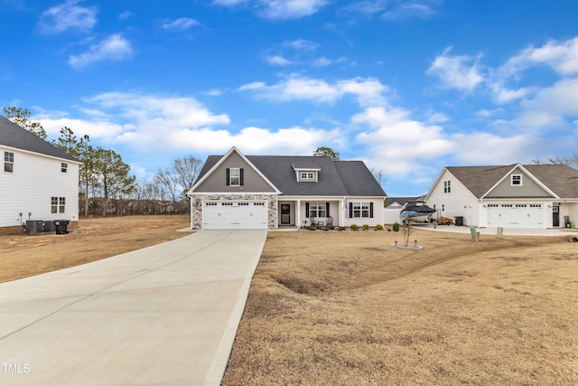 view of front facade with stone siding, covered porch, and driveway