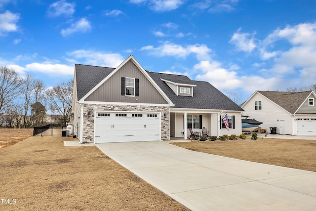 view of front of property with a garage, stone siding, roof with shingles, and concrete driveway