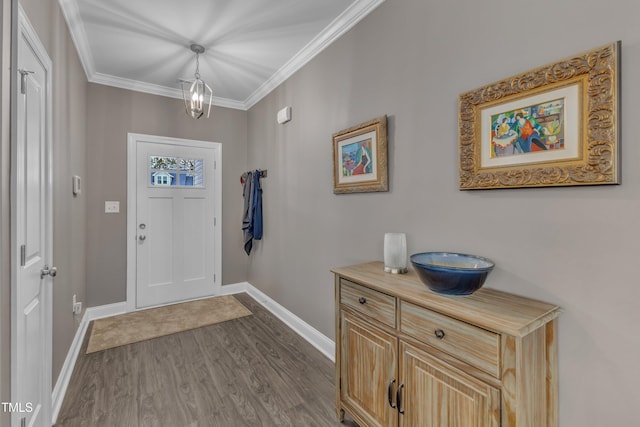 foyer entrance featuring baseboards, dark wood-type flooring, and ornamental molding