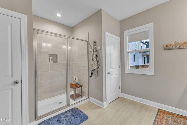 full bathroom with baseboards and a stall shower