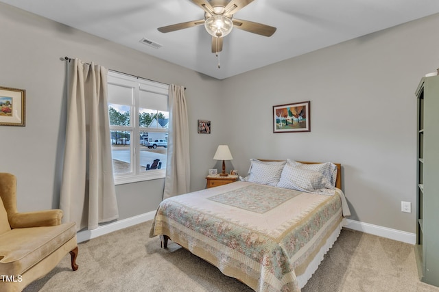 bedroom with carpet flooring, baseboards, visible vents, and a ceiling fan