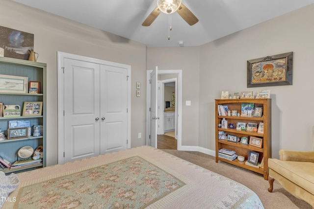 bedroom with a ceiling fan, a closet, carpet floors, and baseboards