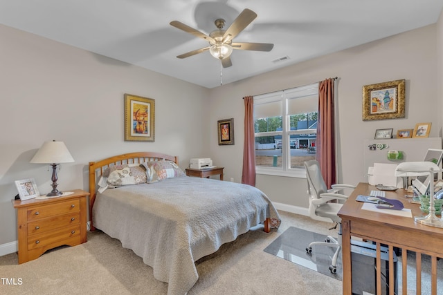 bedroom featuring visible vents, baseboards, ceiling fan, and carpet flooring