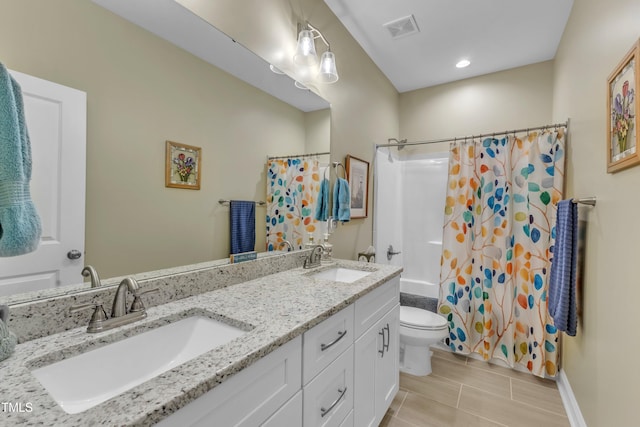 full bath featuring double vanity, toilet, visible vents, and a sink