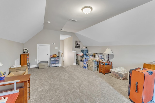 additional living space with visible vents, lofted ceiling, and carpet floors