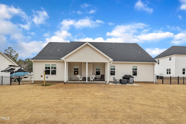 rear view of property with fence, a yard, a shingled roof, ceiling fan, and a patio area