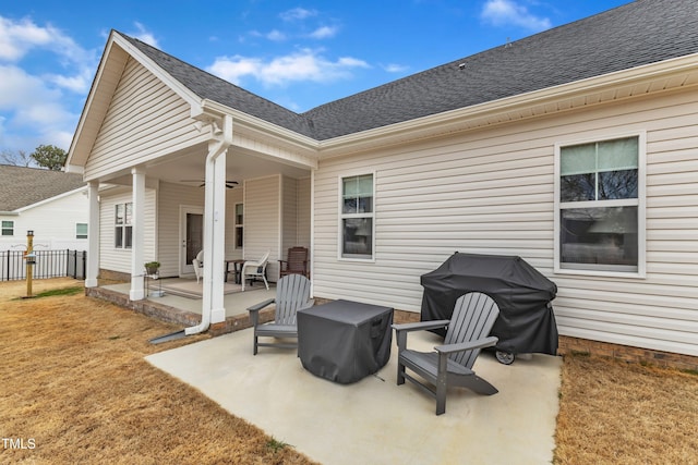 view of patio with a grill, a ceiling fan, and fence