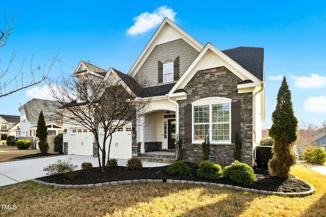 view of front of property with a garage, stone siding, driveway, and a shingled roof