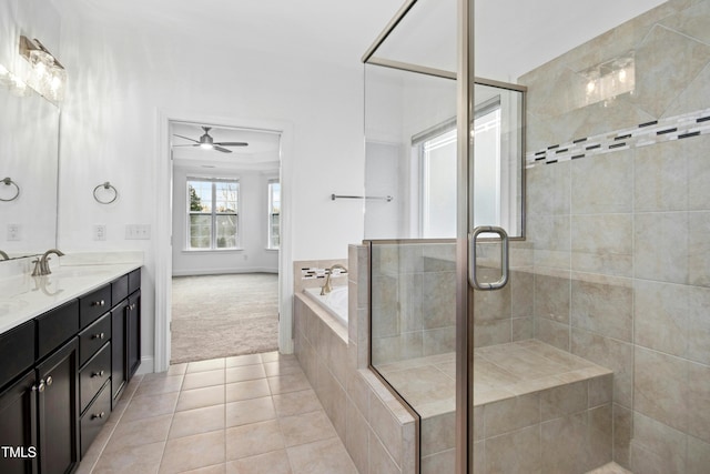 full bath featuring tile patterned floors, a stall shower, a bath, and a sink