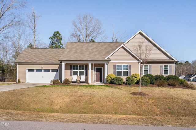 view of front of property with an attached garage, driveway, and a front yard