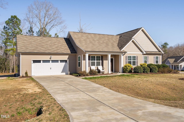 view of front of house with a garage, concrete driveway, a front lawn, and a shingled roof