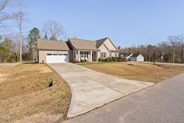 view of front facade featuring an attached garage, concrete driveway, and a front lawn