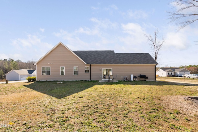 back of property with a yard and a patio