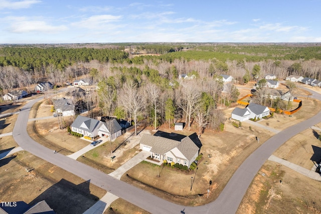 bird's eye view featuring a wooded view