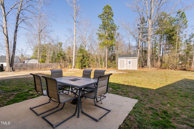 view of patio featuring outdoor dining space, a storage shed, an outdoor structure, and fence