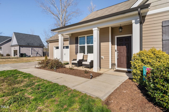 entrance to property with a garage and covered porch