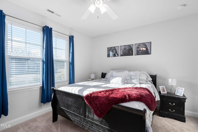 carpeted bedroom featuring visible vents, baseboards, and ceiling fan