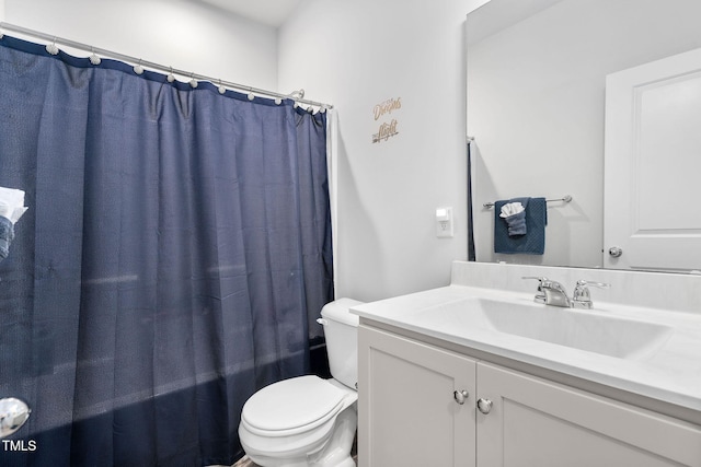 bathroom with a shower with shower curtain, toilet, and vanity