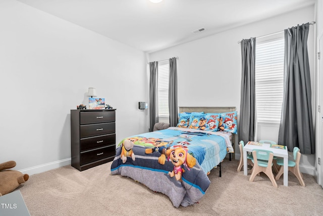 carpeted bedroom with baseboards and visible vents