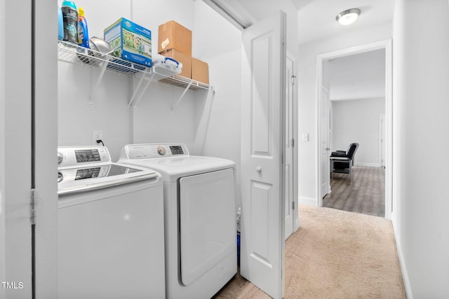 laundry area featuring carpet flooring, baseboards, washing machine and dryer, and laundry area