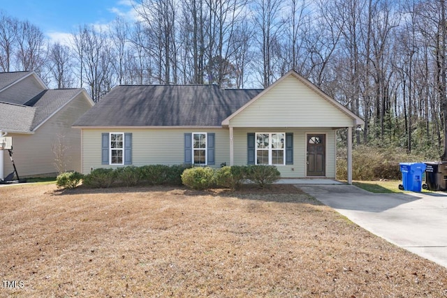 ranch-style home with a front lawn, driveway, and roof with shingles