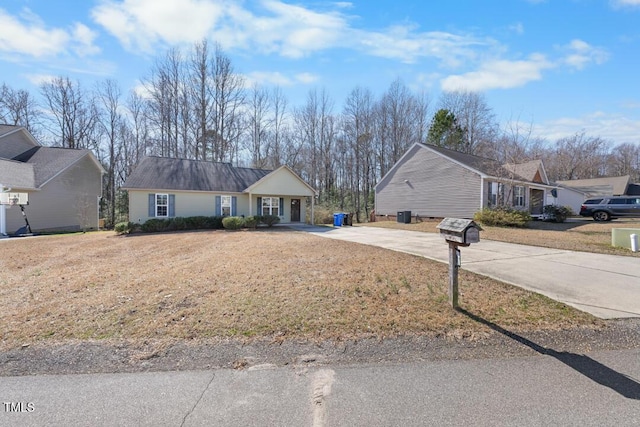 ranch-style house with driveway and a front yard