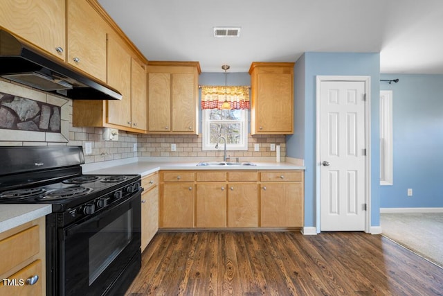 kitchen featuring visible vents, a sink, under cabinet range hood, black / electric stove, and light countertops