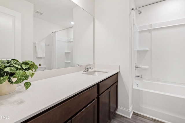 97 Begonia St, Angier, NC 27501 - full bathroom featuring bathing tub / shower combination, vanity, baseboards, wood finished floors, and toilet