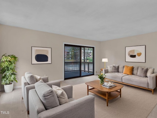 living room with baseboards and light carpet