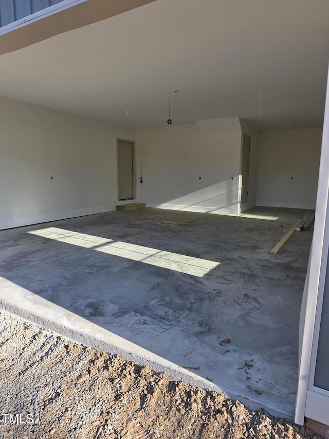 interior space with concrete floors and baseboards